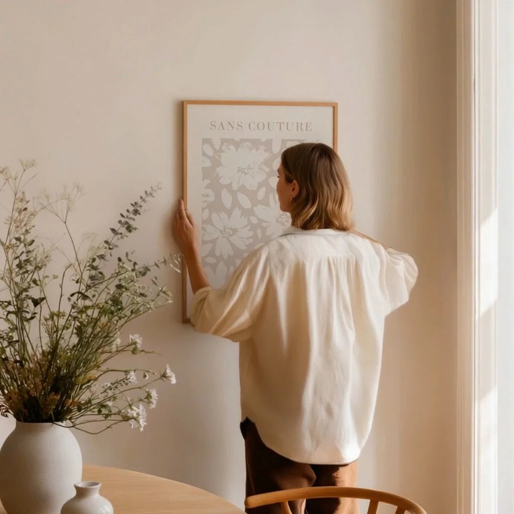 Pastel beige floral poster styled in bright minimalist bedroom interior